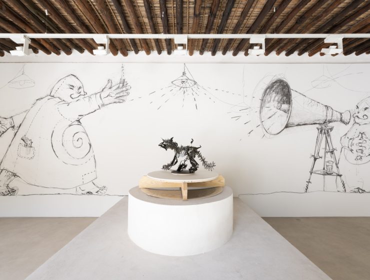 In the front: William Kentridge, Cat / Coffee Pot IV, 2019. From ‘Ubu’, 1996–1997. Installation view: William Kentridge: A Shadow of a Shadow, Bait Al Serkal, Arts Square, 2024. Photo: Motaz Mawid In the back: William Kentridge, Site specific installation of Ubu drawings, 2024.From ‘Ubu’, 1996–1997. Installation view: William Kentridge: A Shadow of a Shadow, Bait Al Serkal, Arts Square, 2024. Photo: Motaz Mawid
