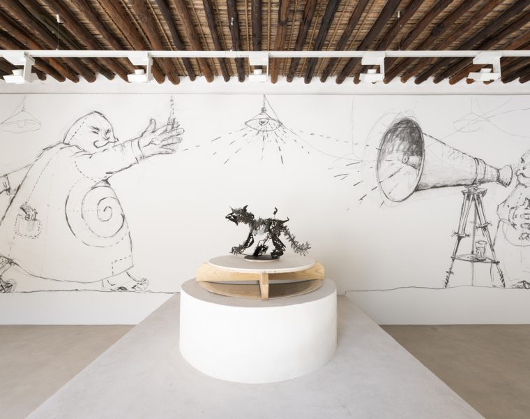 In the front: William Kentridge, Cat / Coffee Pot IV, 2019. From ‘Ubu’, 1996–1997. Installation view: William Kentridge: A Shadow of a Shadow, Bait Al Serkal, Arts Square, 2024. Photo: Motaz Mawid In the back: William Kentridge, Site specific installation of Ubu drawings, 2024.From ‘Ubu’, 1996–1997. Installation view: William Kentridge: A Shadow of a Shadow, Bait Al Serkal, Arts Square, 2024. Photo: Motaz Mawid